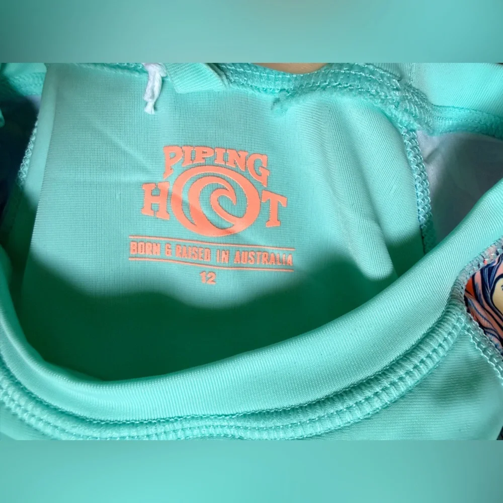 Piping Hot brand rash guard features a mint green. Size 12